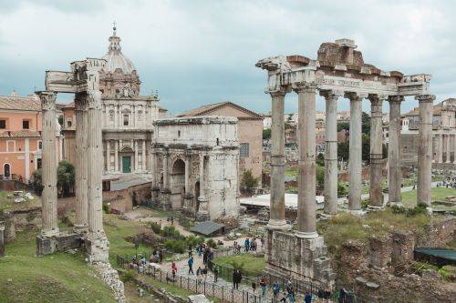 ROME, ITALY - 16 MAY 2016: Tourists visiting ancient ruins in antique Roman Forum
